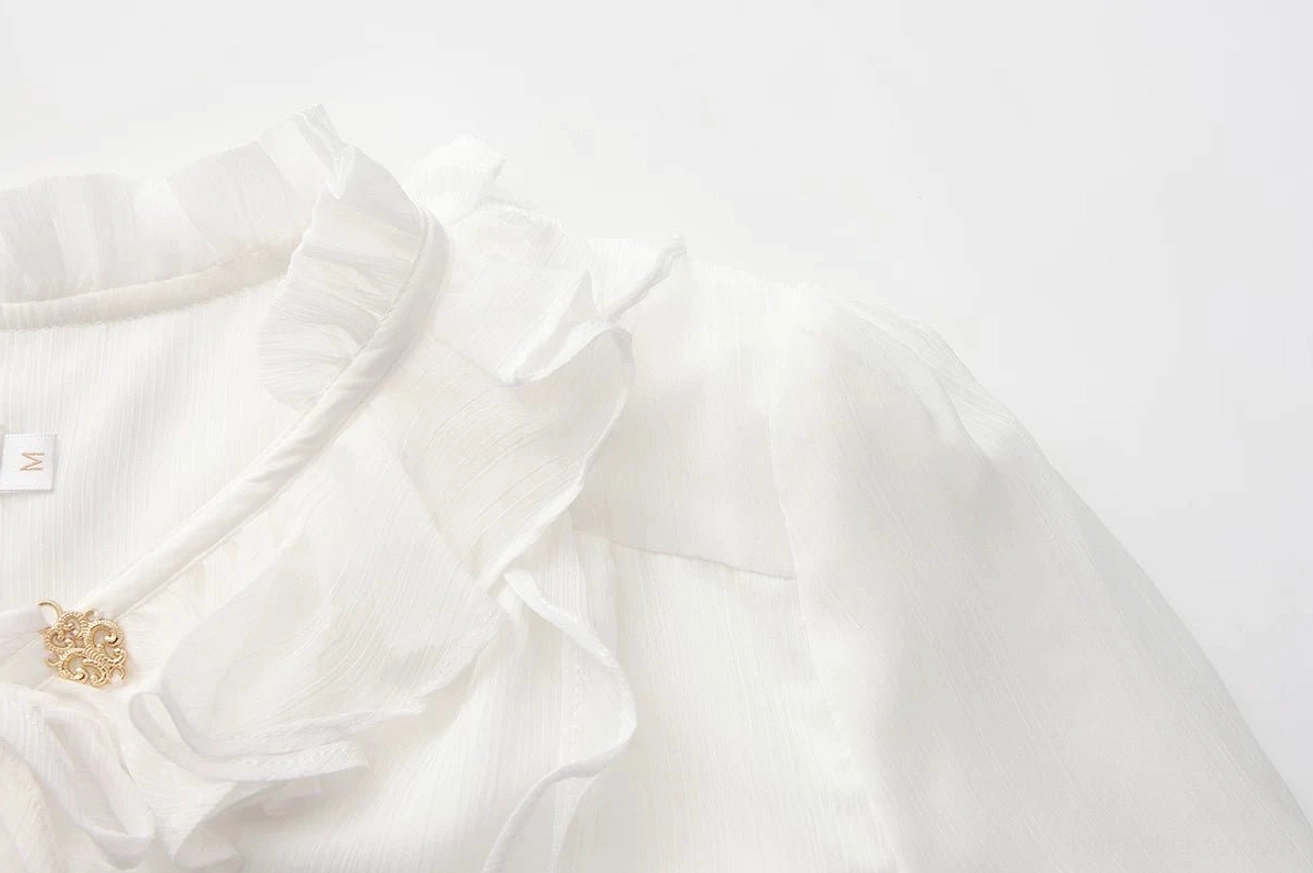 Side view macro detail of white pirate prince ouji lolita blouse ruffled stand collar with single vintage gold decorative button and size tag on inner collar, side angle detail