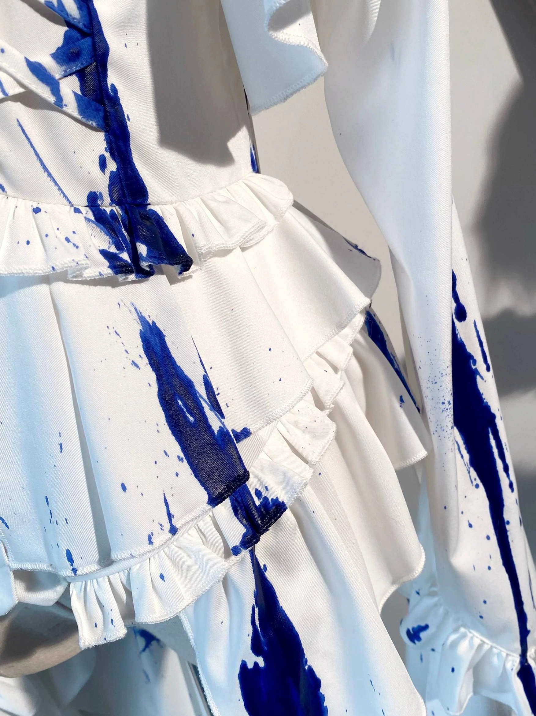 Matte satin fabric quality and drape demonstration on Ouji lolita blouse, showcasing premium white satin construction with superior texture and luxurious appearance
