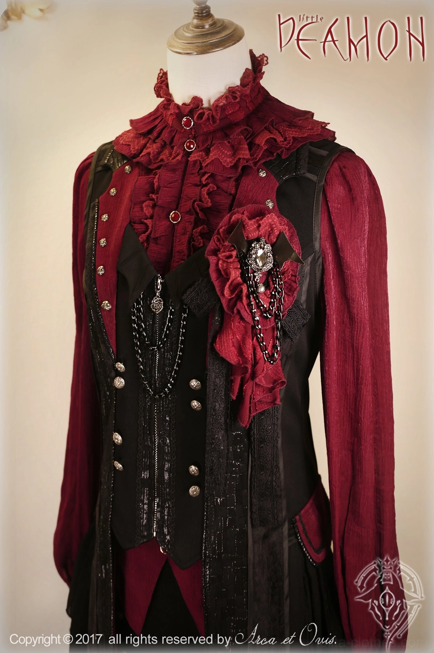 Burgundy red and black two-piece Ouji lolita outfit with ruffled collar, decorative brooch, chain embellishments and tailcoat-style hem