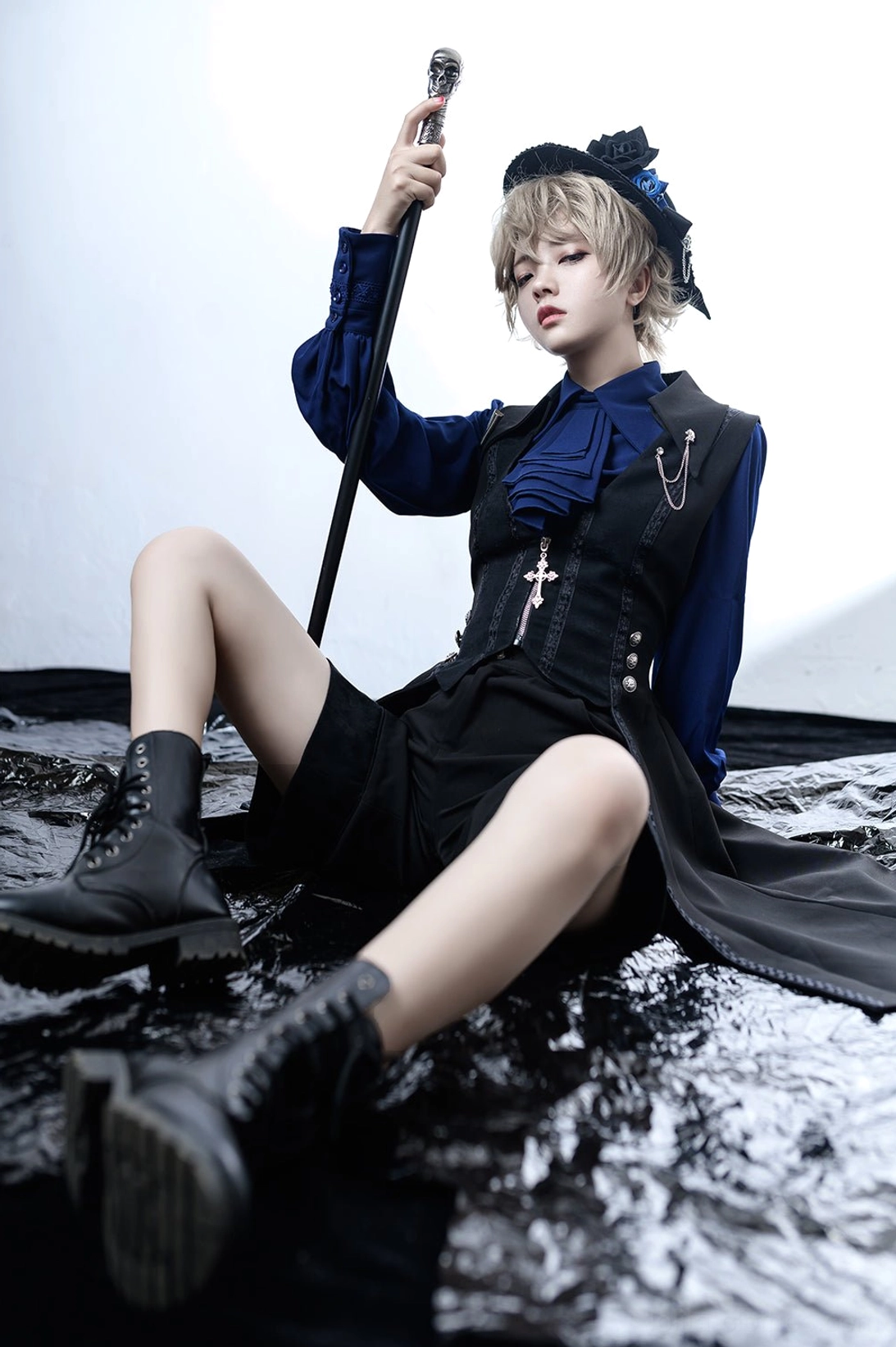 lying pose low angle shot model black and blue gothic Ouji lolita coordinate black shorts asymmetrical hem tail vest design display