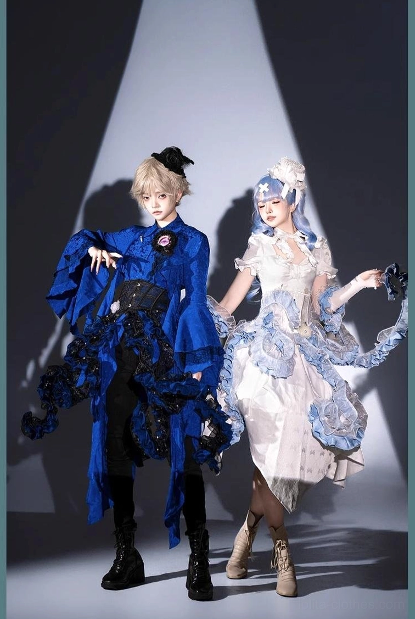 Two models side by side styling comparison - left model in royal blue gothic Ouji Lolita with dark ruffled asymmetrical trim and right model in white-blue gradient frilly Lolita dress, studio spotlight background