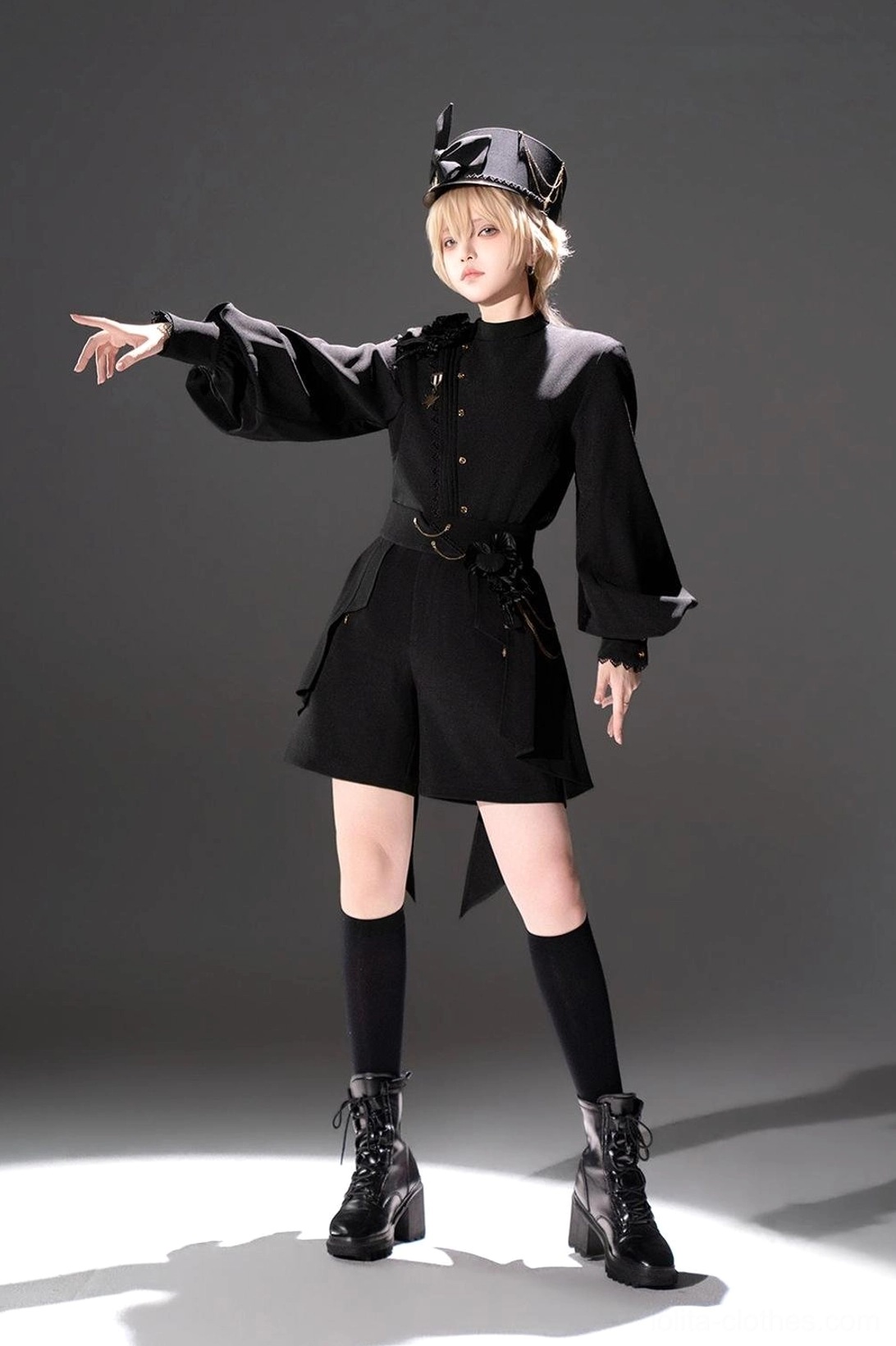 Black Ouji Lolita military style two-piece set front view blonde model posing with one arm stretched out wearing belted waist loose-fitting shorts