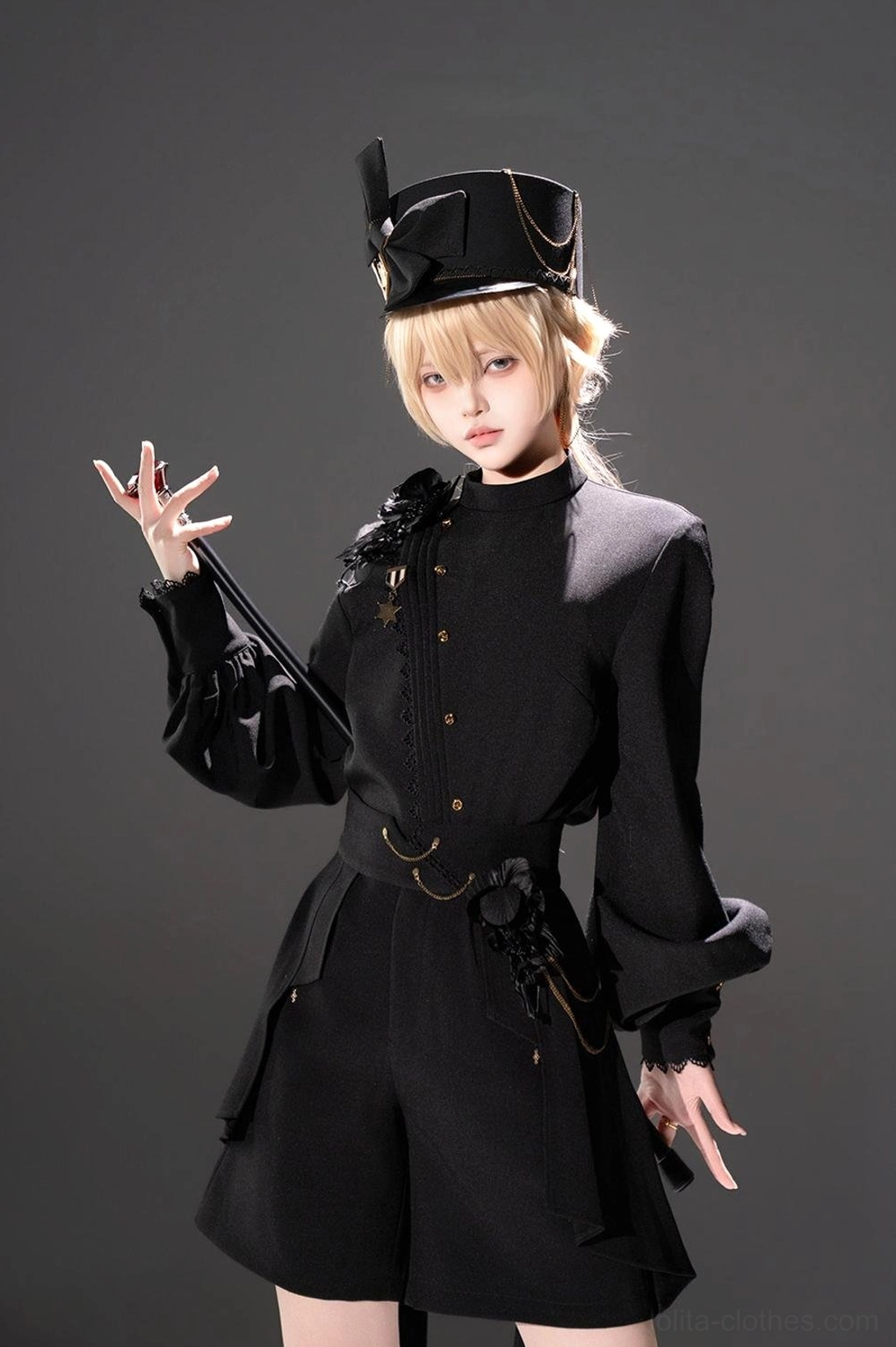 Ouji Lolita military shirt and high-low shorts set front three-quarter view with blonde model wearing military top hat and lantern sleeve blouse with tailored shorts