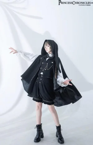 Ouji lolita prince complete set full-body front view featuring black and white color blocking, decorative gold chains, ruffled shorts hem, styled with black ankle boots