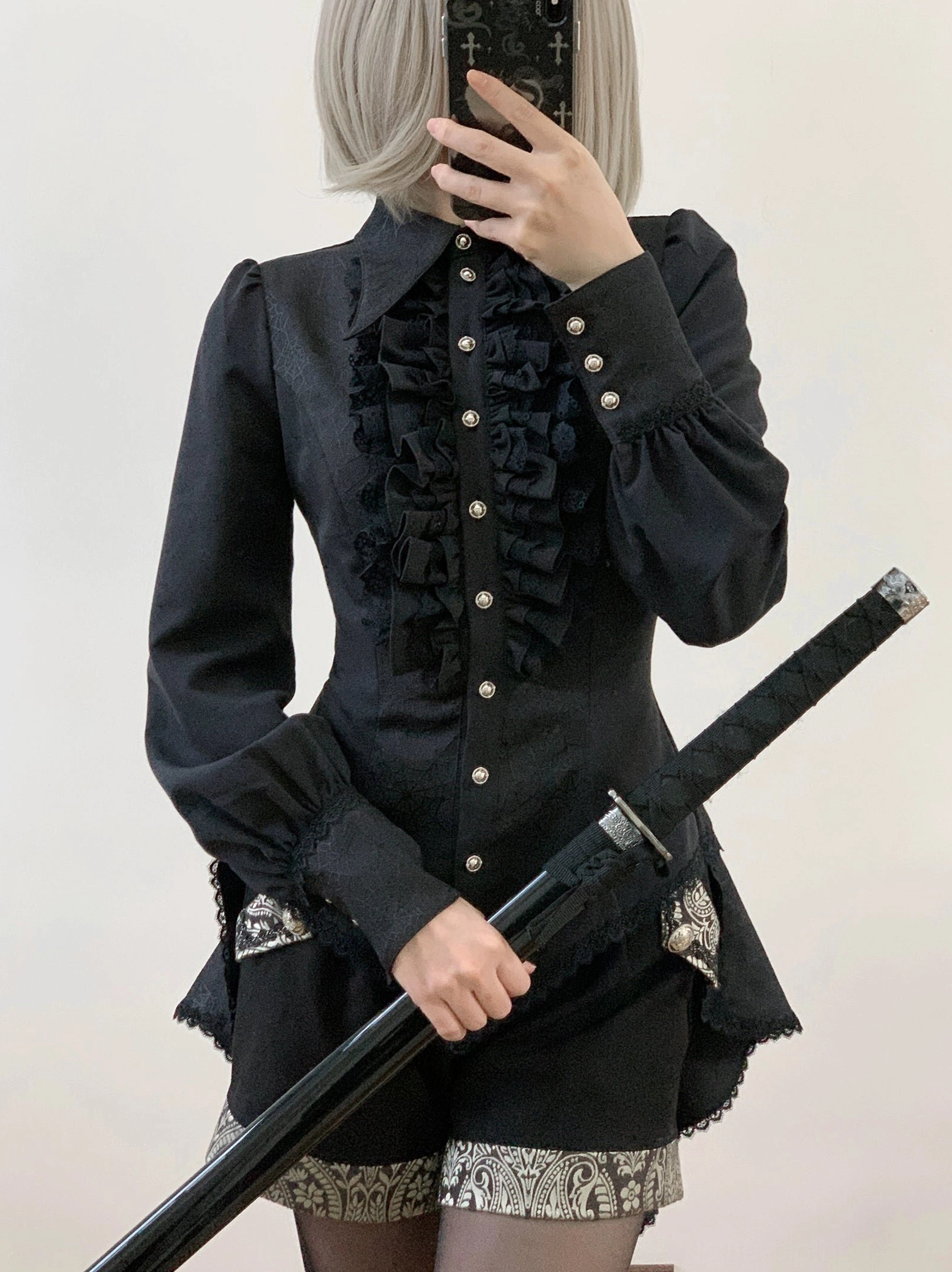 Gothic Ouji lolita spiderweb shirt detail view of black lace ruffles front placket layering and decorative spiderweb motif closeup