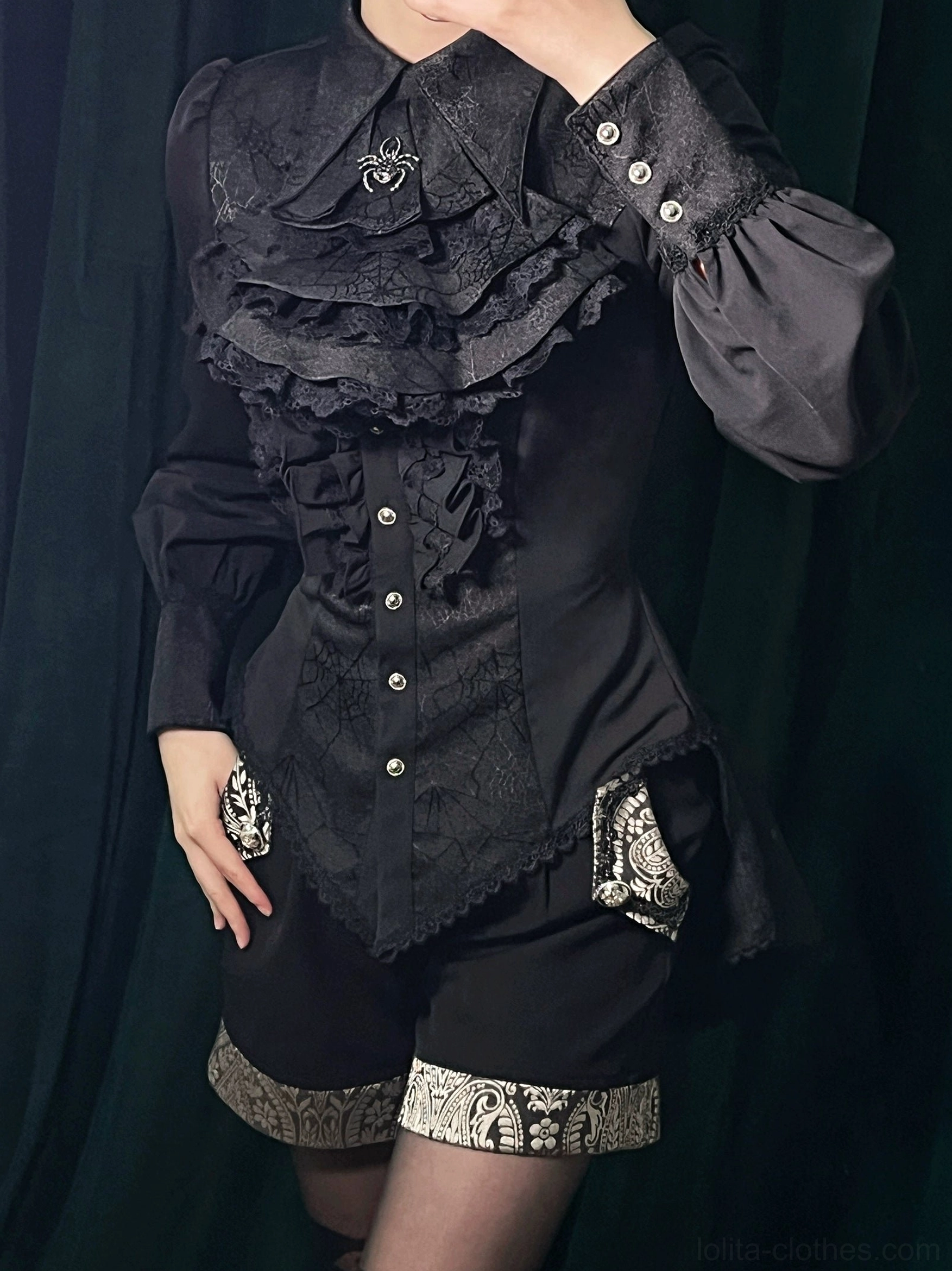 Black gothic Ouji lolita spiderweb shirt front display showing ruffled chest lace black pearl buttons pointed hemline and structure