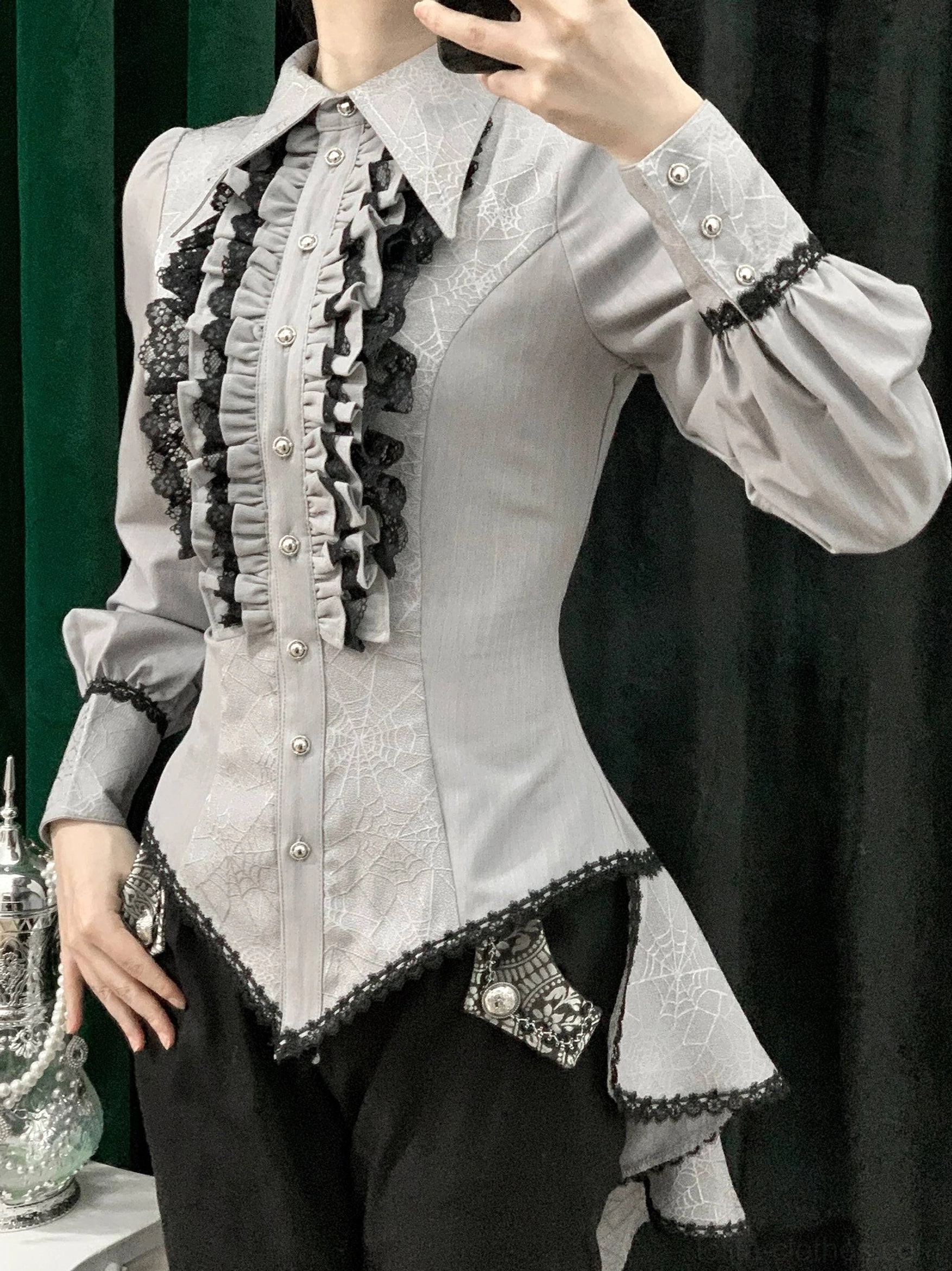 Light gray gothic Ouji lolita shirt front view on model showing corset fitted silhouette pearl button closures asymmetrical hem and spiderweb jacquard fabric