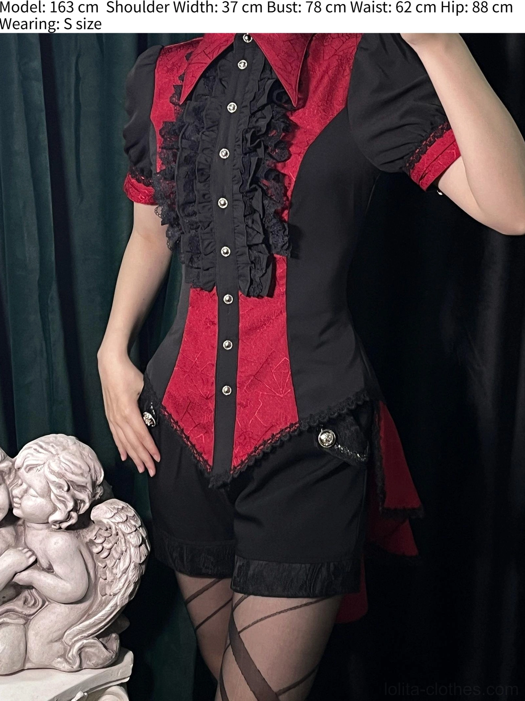 Red gothic Ouji lolita spiderweb shirt front display on dress form showing spiderweb pattern black lace details and pointed design elements