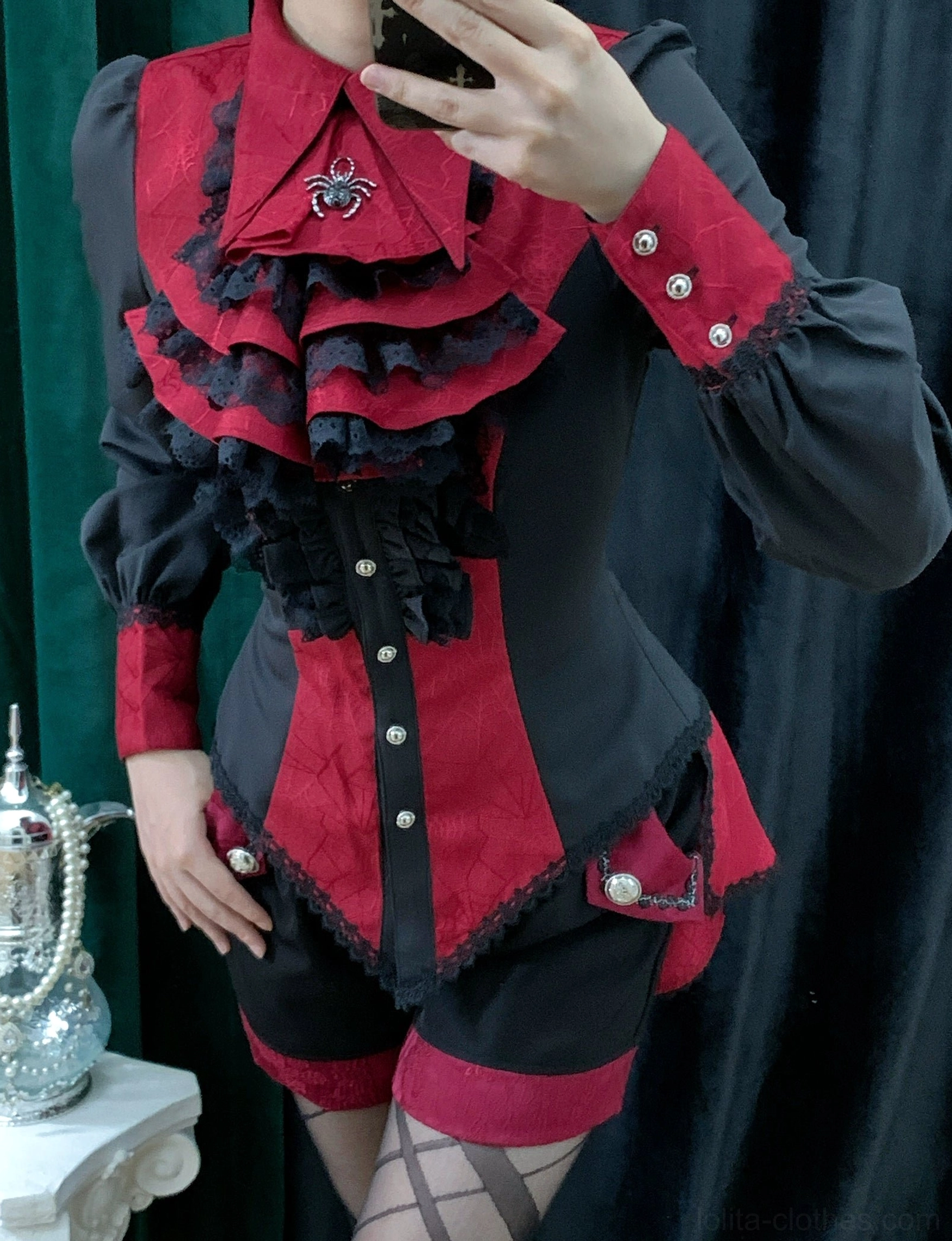 Red gothic Ouji lolita spiderweb shirt worn by model front view showing fitted silhouette ruffled front lace and spiderweb fabric