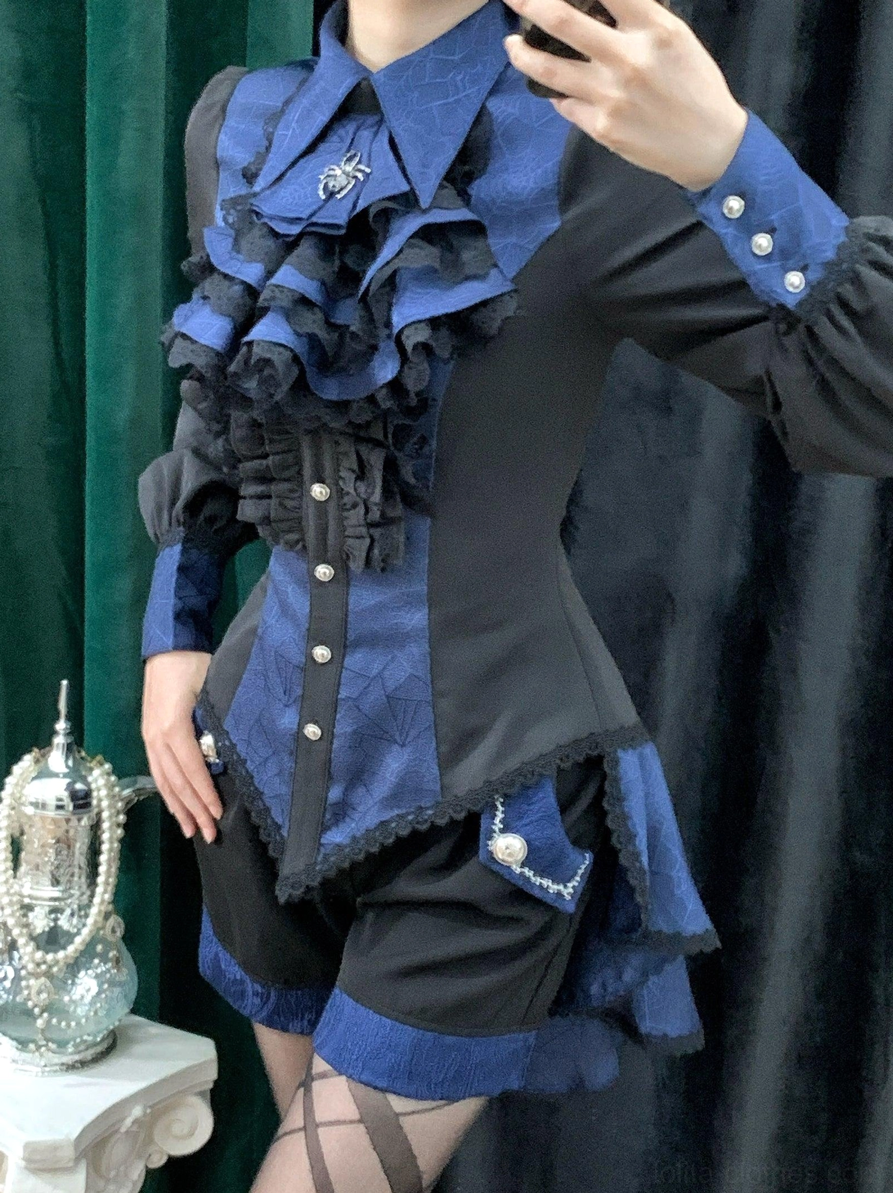 Gothic Ouji lolita spiderweb shirt worn by model three-quarter view showing silhouette proportions sleeve length and hemline design