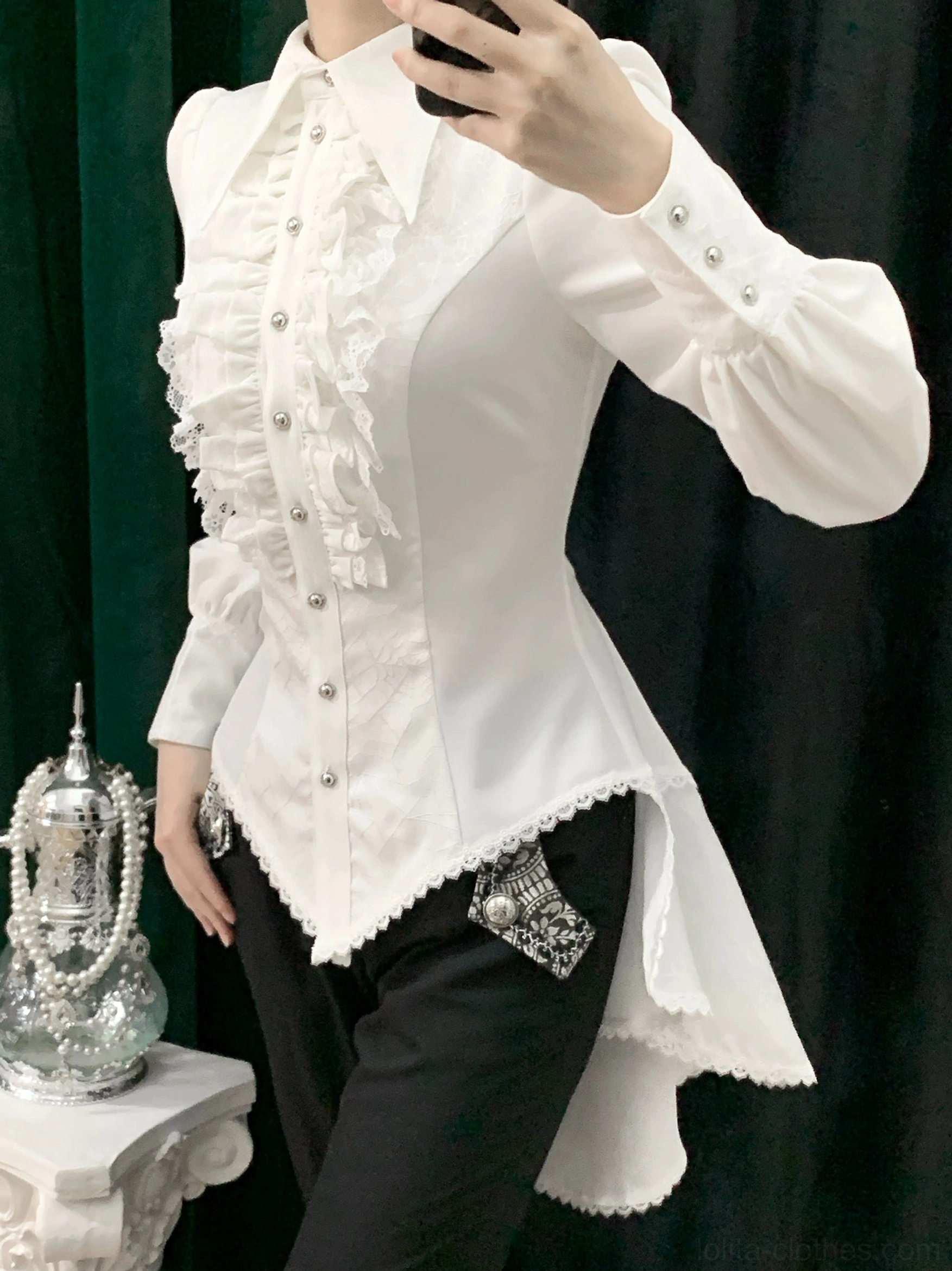 White gothic Ouji lolita spiderweb shirt side view on model showing asymmetrical high-low tail hemline fitted silhouette and decorative hip patches