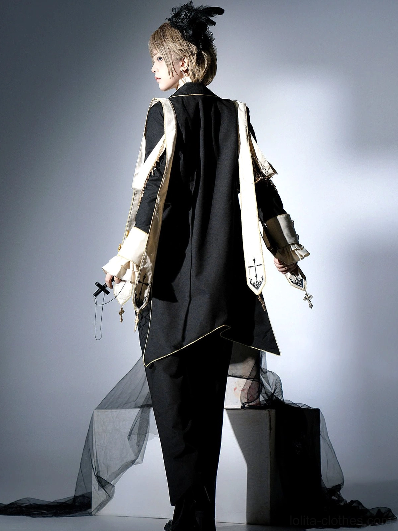 Ouji gothic lolita tailored suit back three-quarter view black tulle prop cream sash waist cross pendant black trousers