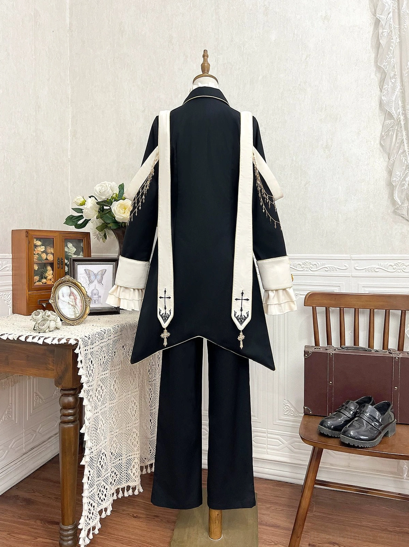 Ouji lolita tailcoat detail view golden trim swallowtail design cross embroidery wide straps metal hardware