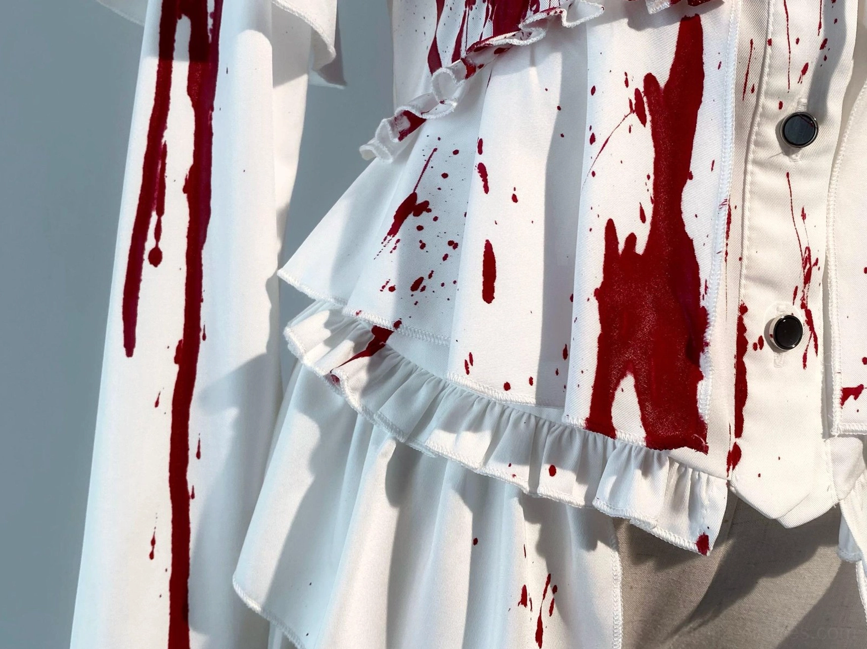 Complete Ouji lolita blouse styling flat lay showing all design elements including ruffled collar, sleeve panels, trailing hem, and lace-up back detail on white satin