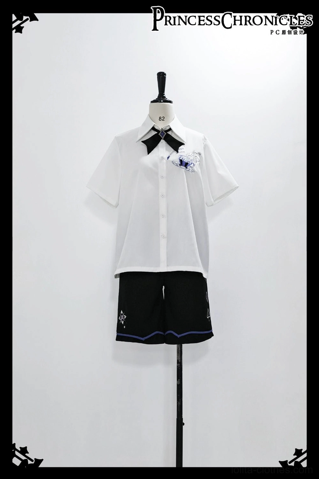 Ouji prince style outfit flat lay on mannequin showing loose short-sleeve shirt chest embroidery and coordinating black shorts with trim details