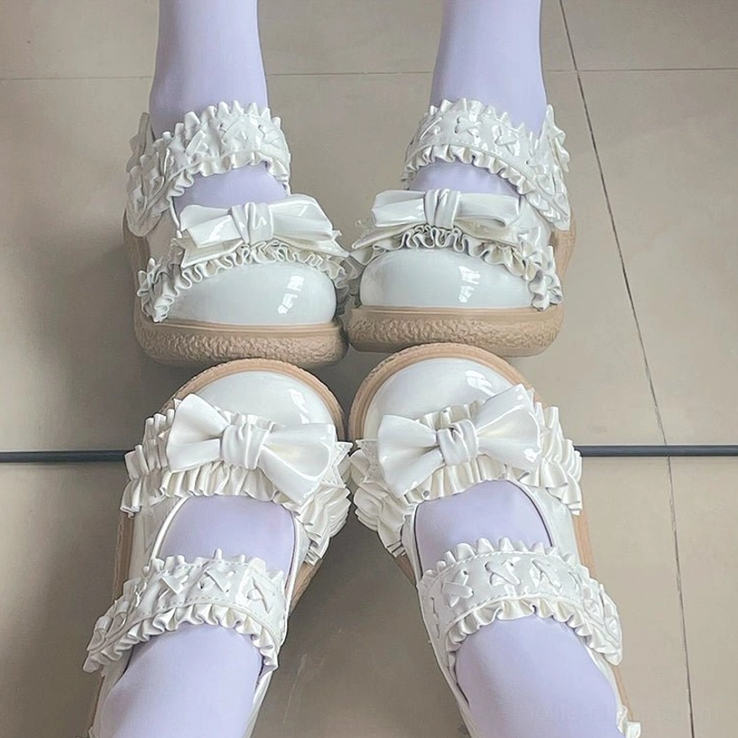 Paint white Lolita shoes detailed product shot with visible patent leather shine, butterfly bow embellishments and ruffled star strap decorative elements