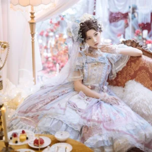 Pastel blue-purple gradient wedding Lolita JSK dress with off-shoulder ruffled sleeves and multi-layered flowing tulle, model with bridal veil and hair flowers in vintage tea lounge