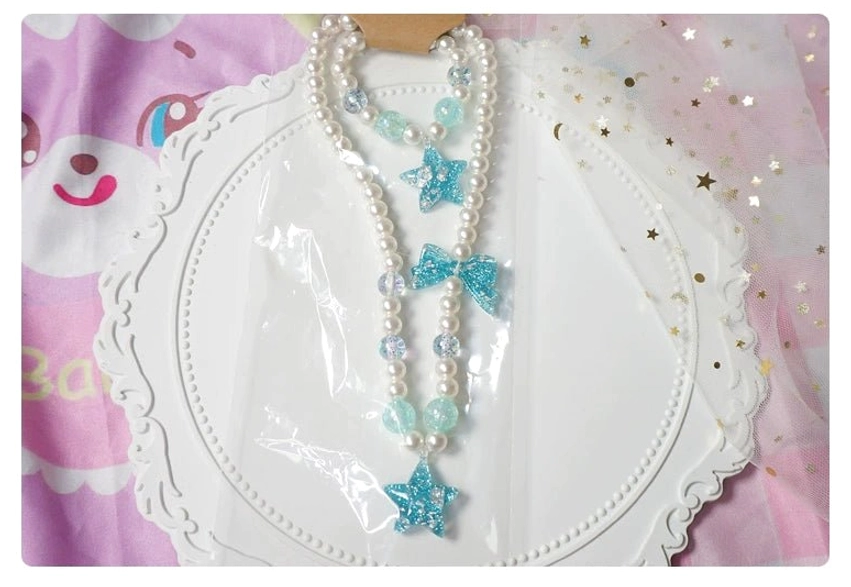 Gradient pastel pearl choker and bracelet lolita jewelry set with heart bow star charms on pink background