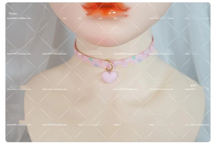 Pastel heart print choker collar neatly worn on BJD doll with pink heart printed strap gold ring and matte pink heart pendant