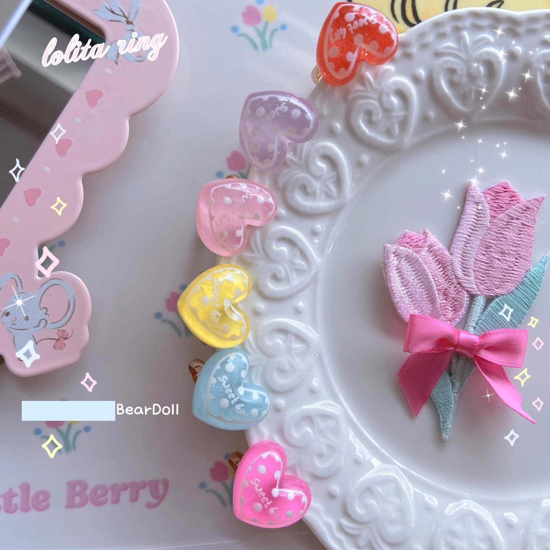 Overhead macro view pastel resin heart rings with printed patterns on decorative dessert plate