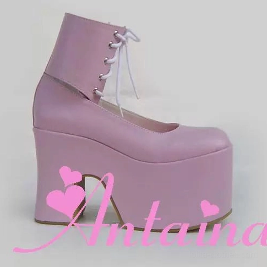 Pastel pink British style lolita platform high heel boots with matte leather finish, round closed toe, lace-up ankle strap, and extra thick platform block heel side view