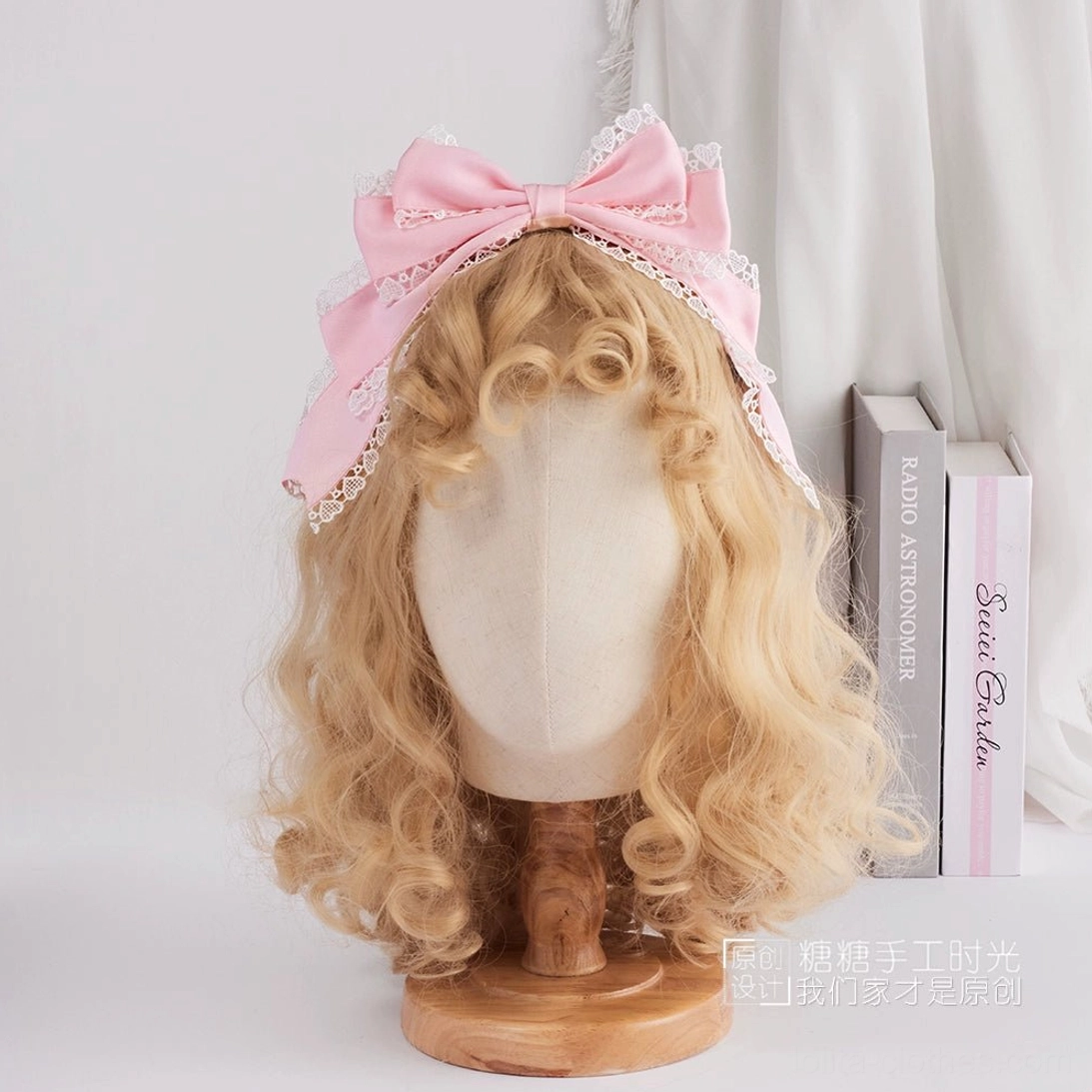 Pastel pink satin sweet lolita bow headdress trimmed with white scalloped lace edging front display on blonde curly wig