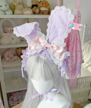 Pastel purple bunny ear lolita hairband with pink satin bow and lace trim displayed on mannequin frontal view