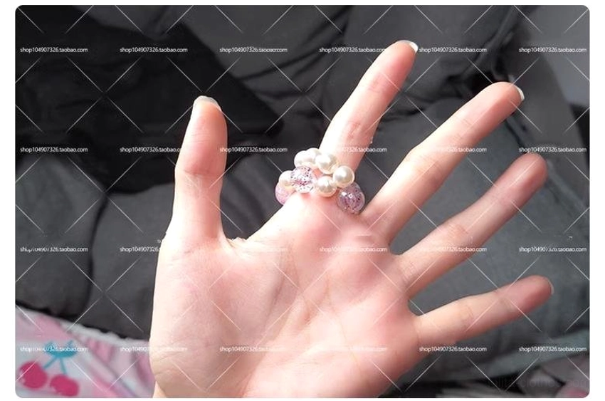 Pastel purple gradient heart charm with multiple stacked imitation pearl beaded rings on finger kawaii jewelry