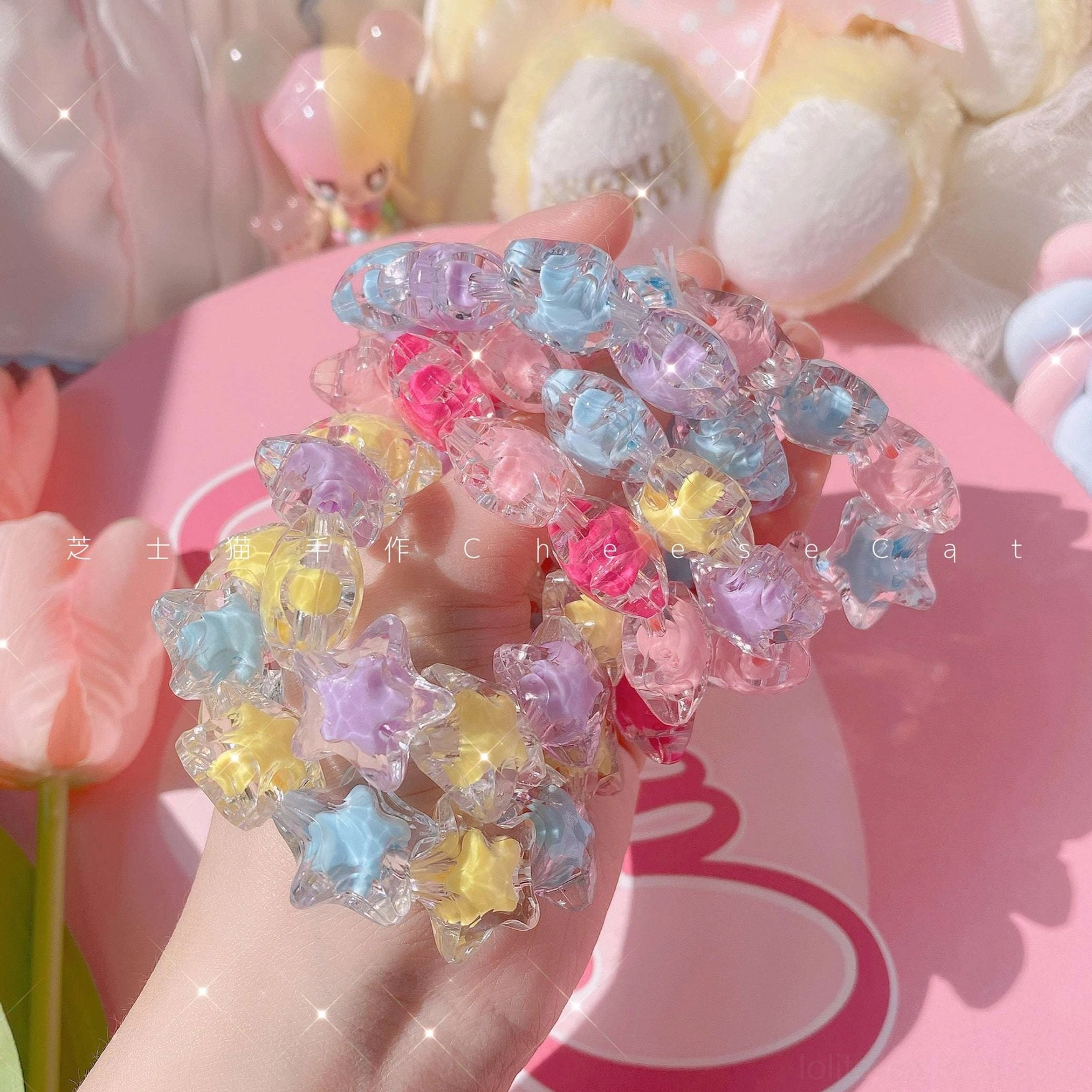 Pastel star crystal beaded Lolita bracelet paired with coordinating rings and hair accessories demonstrating complete sweet Lolita accessory collection aesthetic