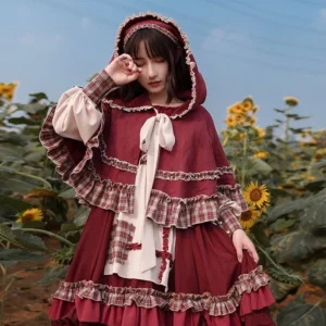 Hooded cape with pastoral Lolita OP dress set, close-up front view of model wearing wine red hooded cloak with lace-trimmed edges and plaid ruffled accents, large front bow detail visible