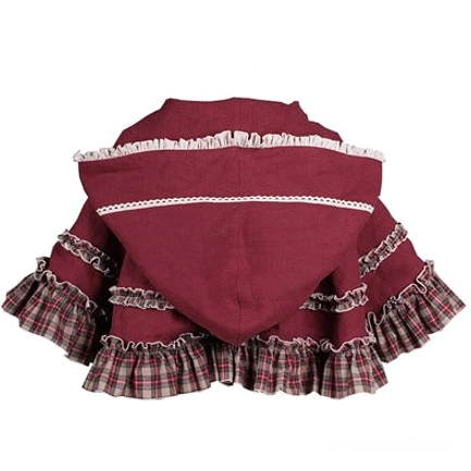 Close-up front view of hooded cape with pastoral Lolita OP dress set, model wearing wine red hooded cloak with classic front bow at hood, plaid fabric accents, and layered ruffled dress details