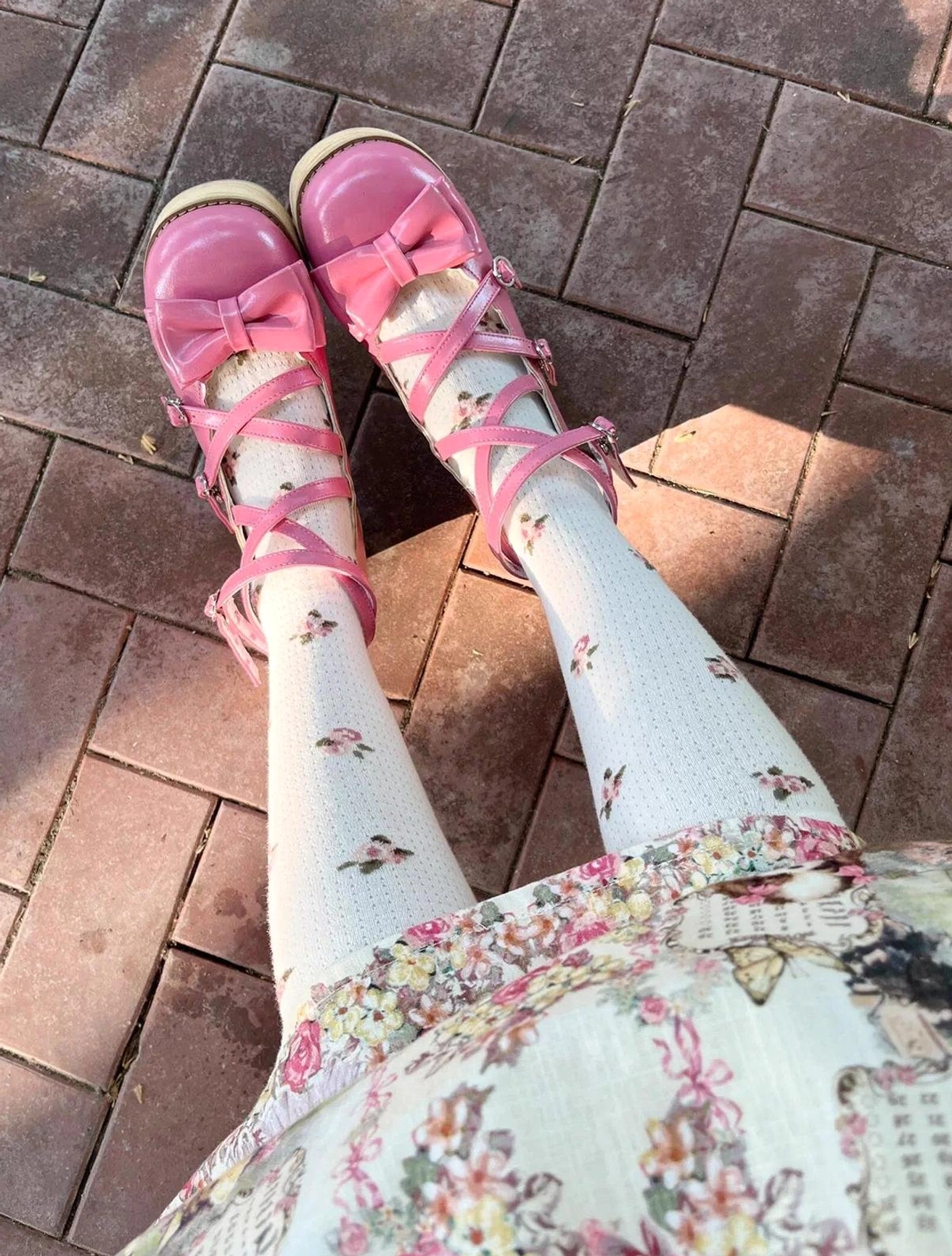 Peach pink lolita platform shoes first person point of view outdoor brick floor sunlight shadows pink leather cross bow strap floral print socks dress coordination