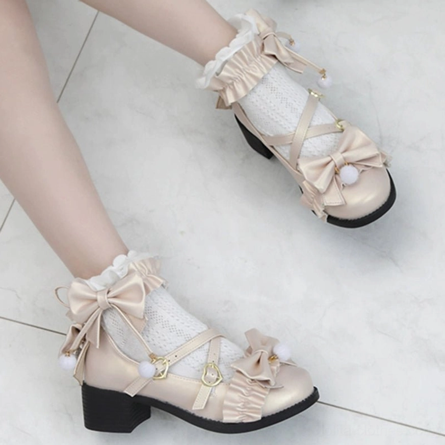 Pearly lustre ivory Lolita Mary Jane shoes with butterfly bow ankle ornament and pom-pom accent, displayed with complementary Lolita fashion accessories and props
