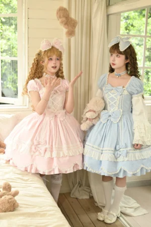 Sweet lolita cotton OP dress with square neckline and puff short sleeves modeled in sunlit bedroom with teddy bears, displaying front bow decoration and layered lace petal hem