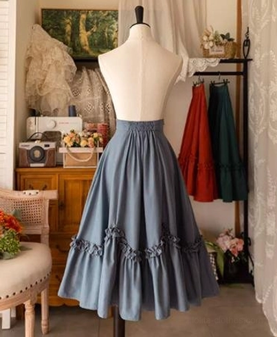 Ivy green petal swing Lolita skirt three-quarter front view on dress mannequin showcasing full flared drape, ruffled hem trim, back waist design, and overall A-line silhouette