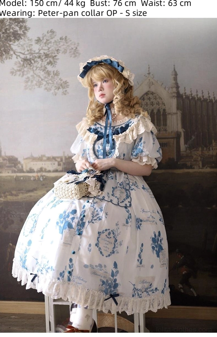 Front medium shot of Peter Pan collar blue and white porcelain Lolita dress with ruffled Peter Pan collar detail, lace skirt hem, front bow neck detail, and woven handbag, photographed in vintage studio with gothic building backdrop