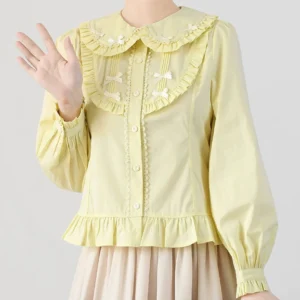 Peter pan doll collar sweet lolita blouse pastel yellow close-up detail lace trim front placket bow accents
