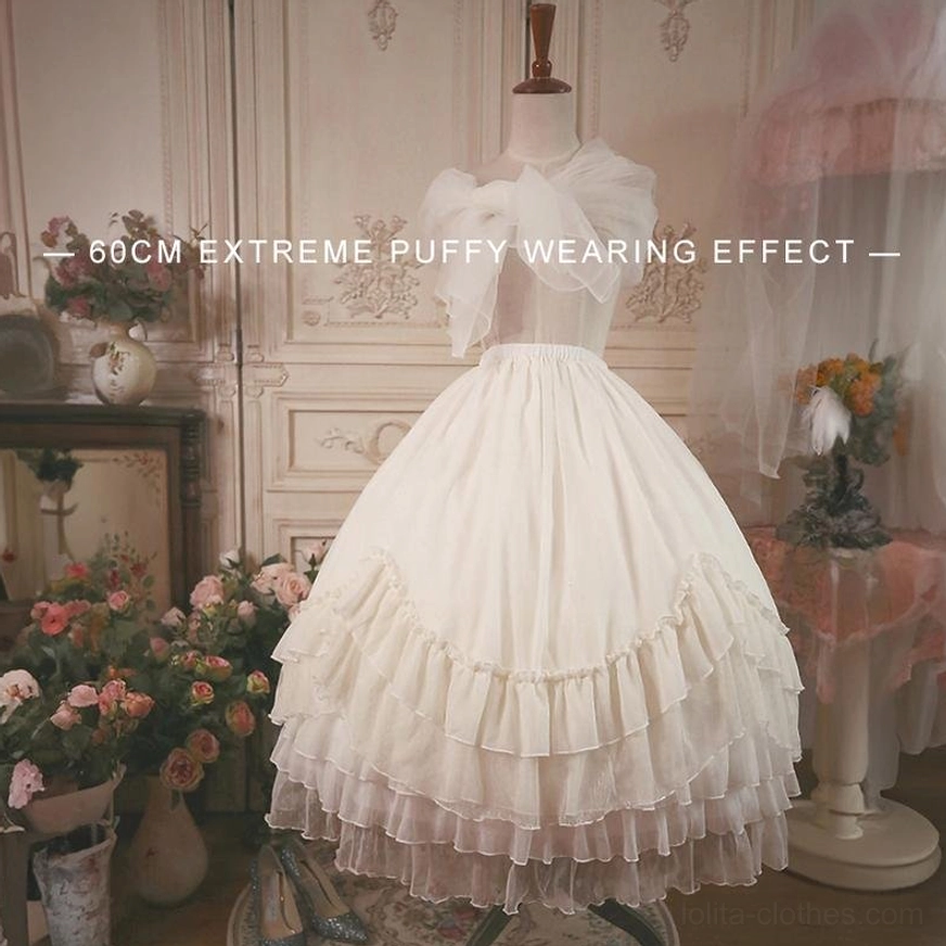 Back three-quarter view of white ruffled petticoat on mannequin showing decorative bow and multi-layered ruffled hem edge, vintage floral studio background