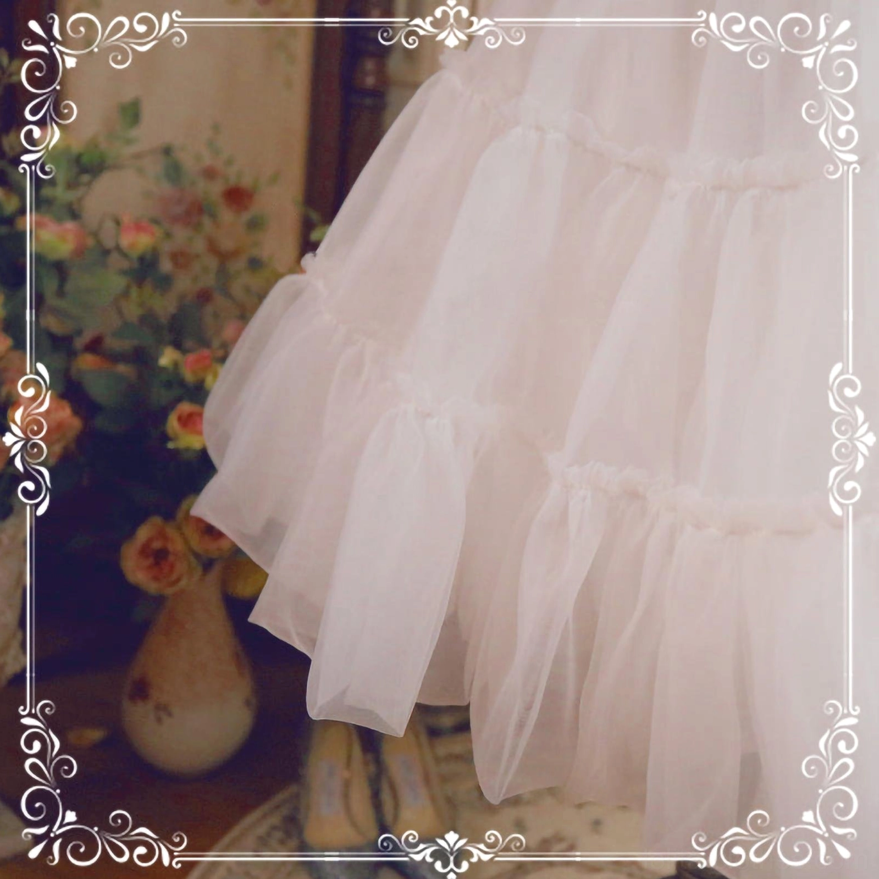 Close-up detail of light pink sheer tulle fabric with ruffled tiered stitching seams petticoat construction