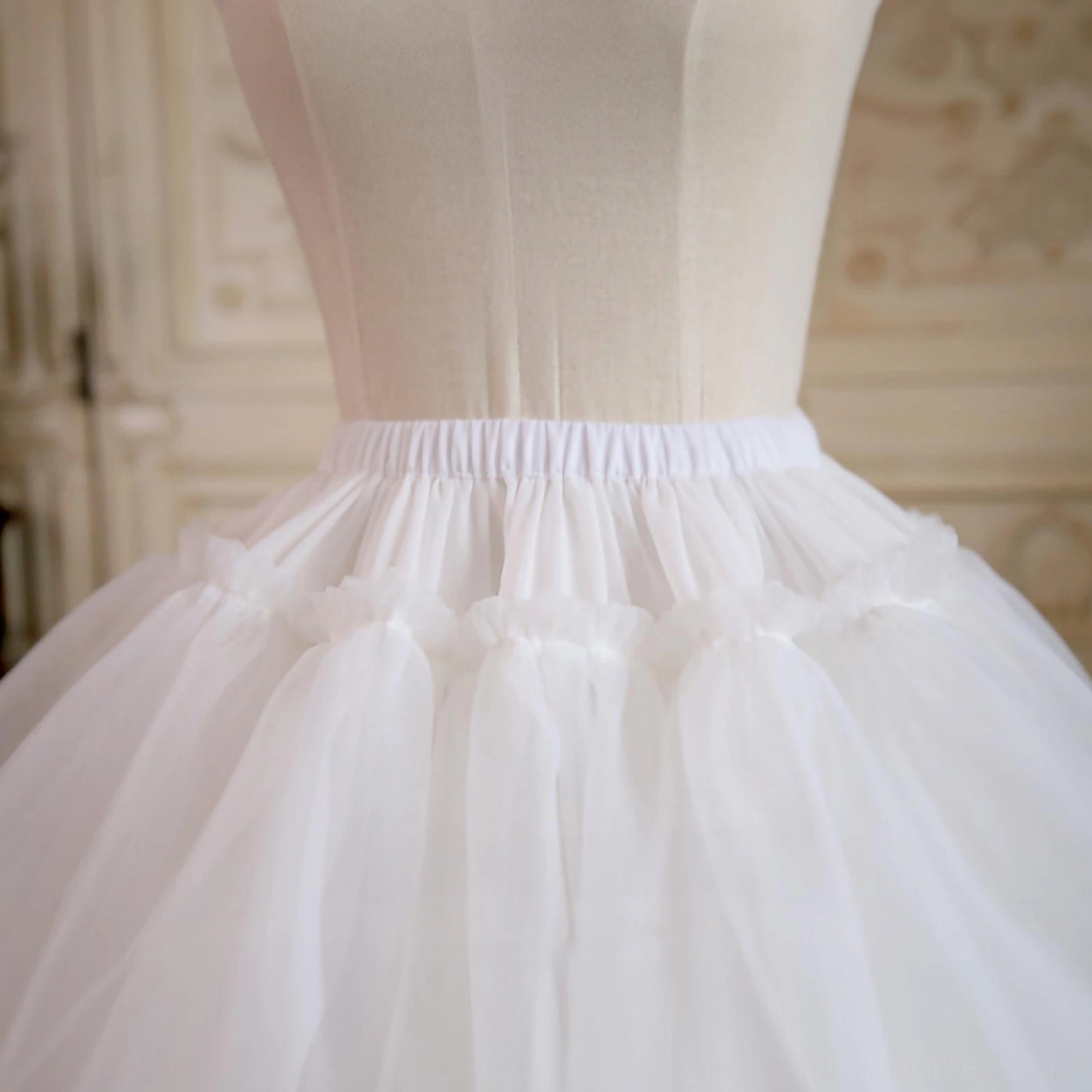 Detailed close-up of petticoat elastic waistband, showing neat stitching on tiered seams, premium cotton lining, and construction craftsmanship