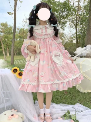 Pink sweet lolita one-piece OP dress with bunny and cloud print, sailor Peter Pan collar, detachable bunny ear clips, heart-shaped front pockets, white lace trims, and voluminous puff sleeves - front three-quarter view outdoor lawn setting