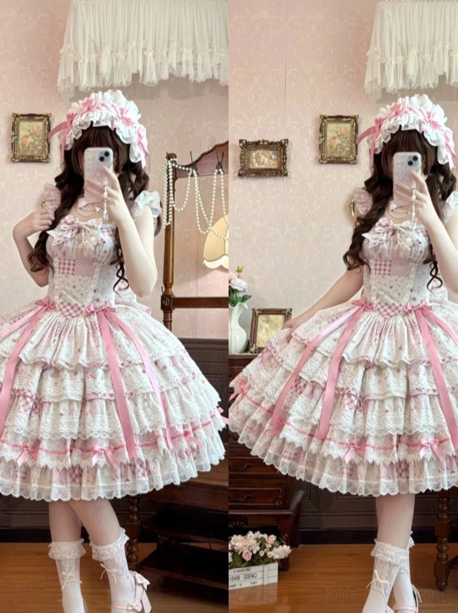 Three-quarter back view of pink floral lolita JSK showing large detachable back bow, layered ruffle hem construction, and halter neck strap adjustment mechanism