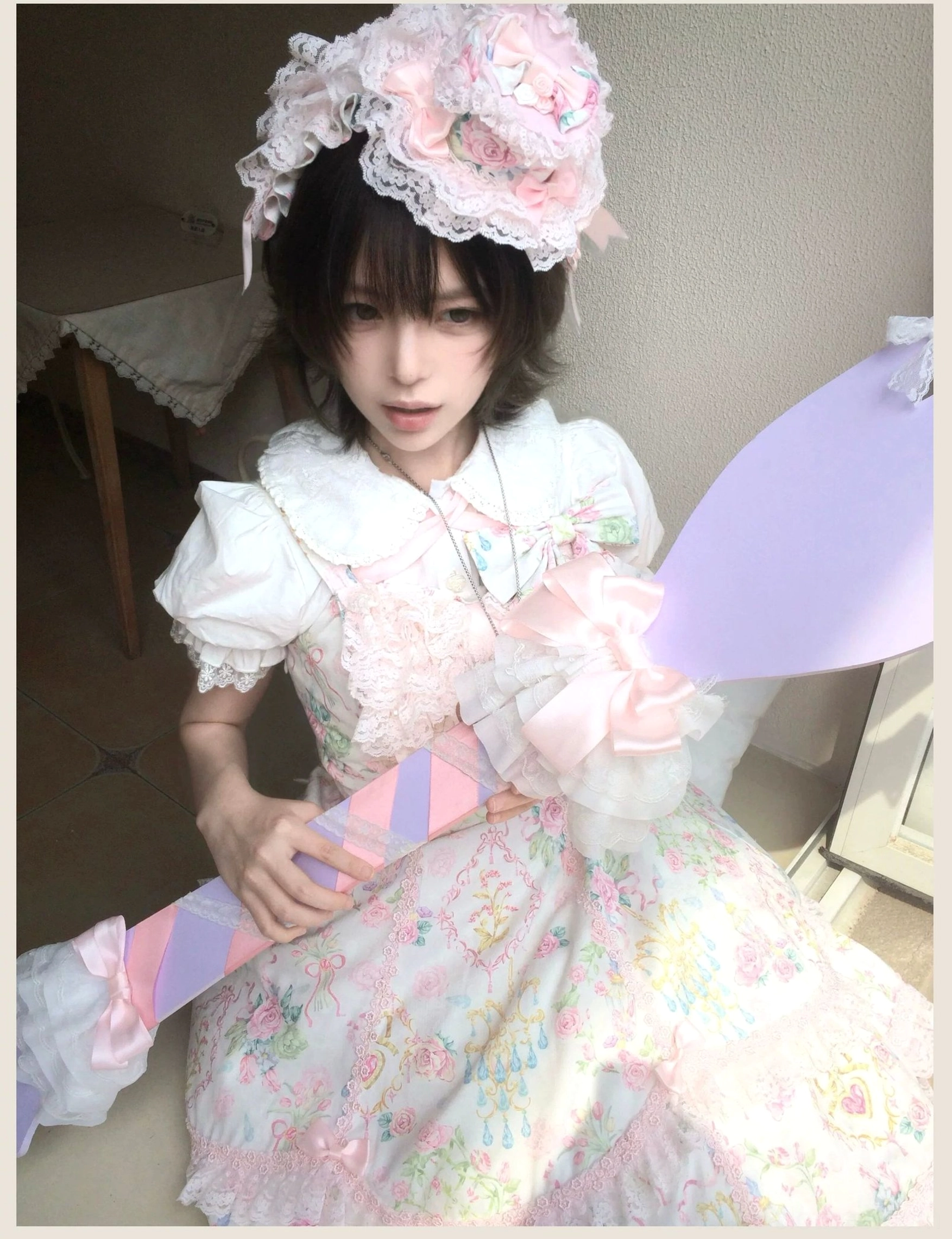 Pink floral Lolita JSK dress with hand washing care instructions and fabric maintenance recommendations display