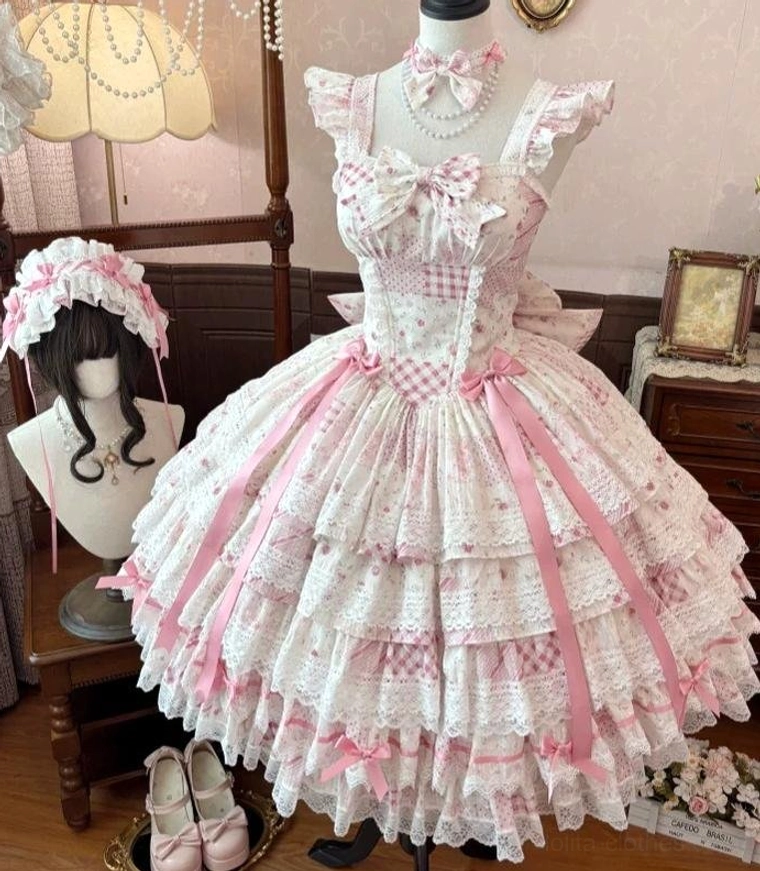 Front full-body mannequin display of pink floral wedding lolita jumper skirt with square neckline bow, multi-layered lace ruffles, and pink floral headdress accessory