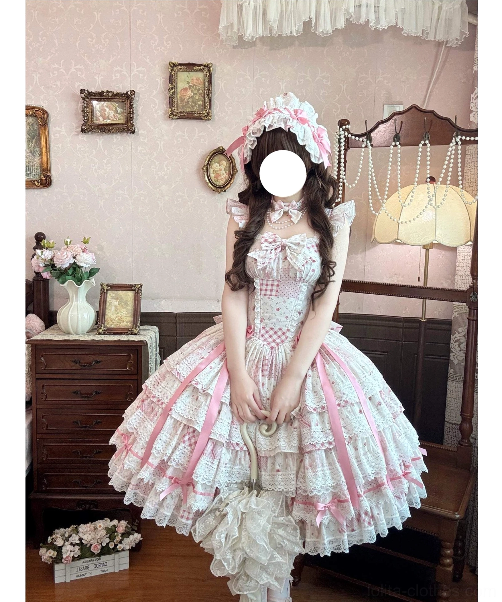 Front view of pink floral wedding lolita JSK dress with tiered ruffle hem, gingham bodice, and satin ribbon accents on female model wearing matching frilly hair accessory