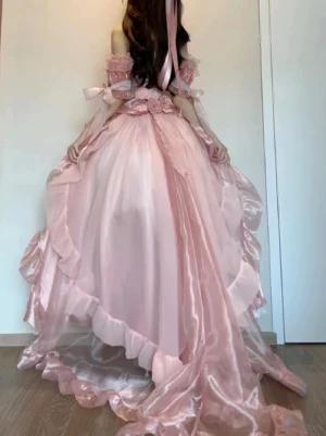 Pink gradient off-shoulder Lolita gown with sheer organza fabric, ruffled high-low trailing hem, and floral shoulder decoration