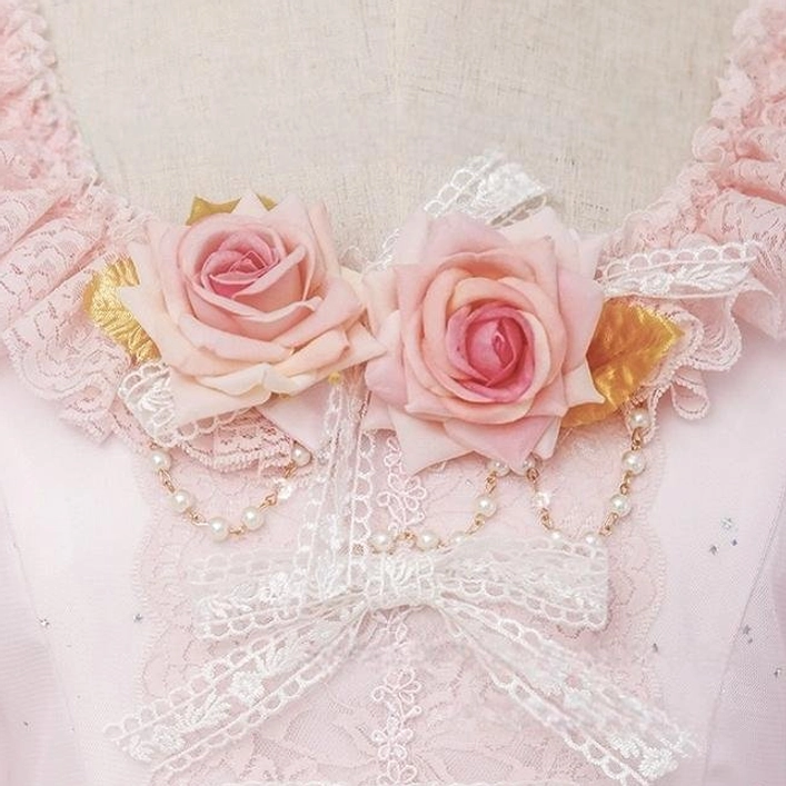 Detailed view of pink Hanamaru brooch sweet Lolita accessory with rose embellishments, pearl accents, and lace ruffled base for coordinate styling