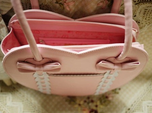 Pink heart-shaped Lolita tote bag opened top-down interior view showing pink fabric lining zippered closure