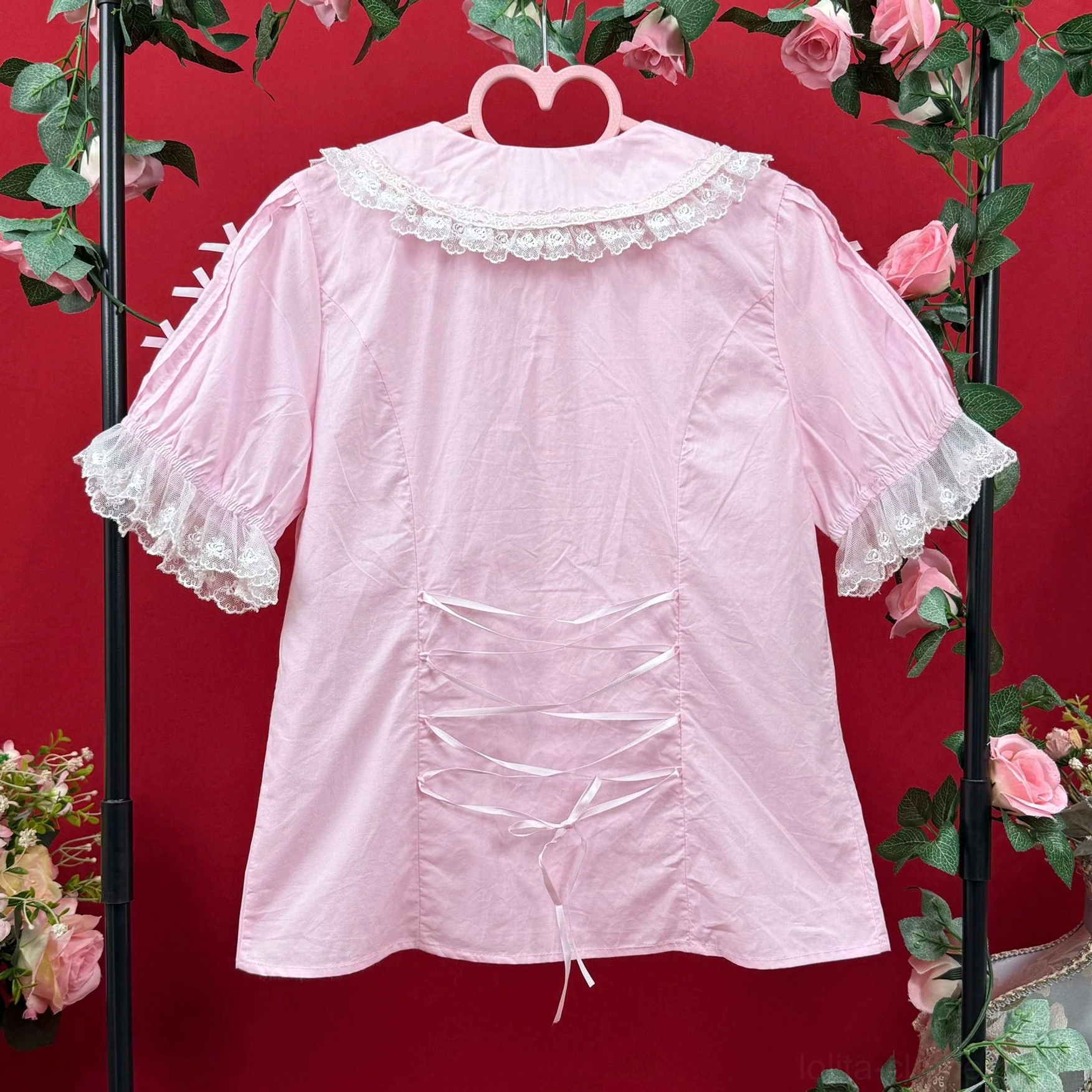 Back view pink lolita cotton blouse featuring lace peter pan collar ruffled short sleeves and crisscross drawstring detail