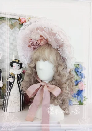 Pink lolita bonnet with artificial flowers lace flounce displayed on head mannequin with curled hair styling in Victorian Christmas aesthetic